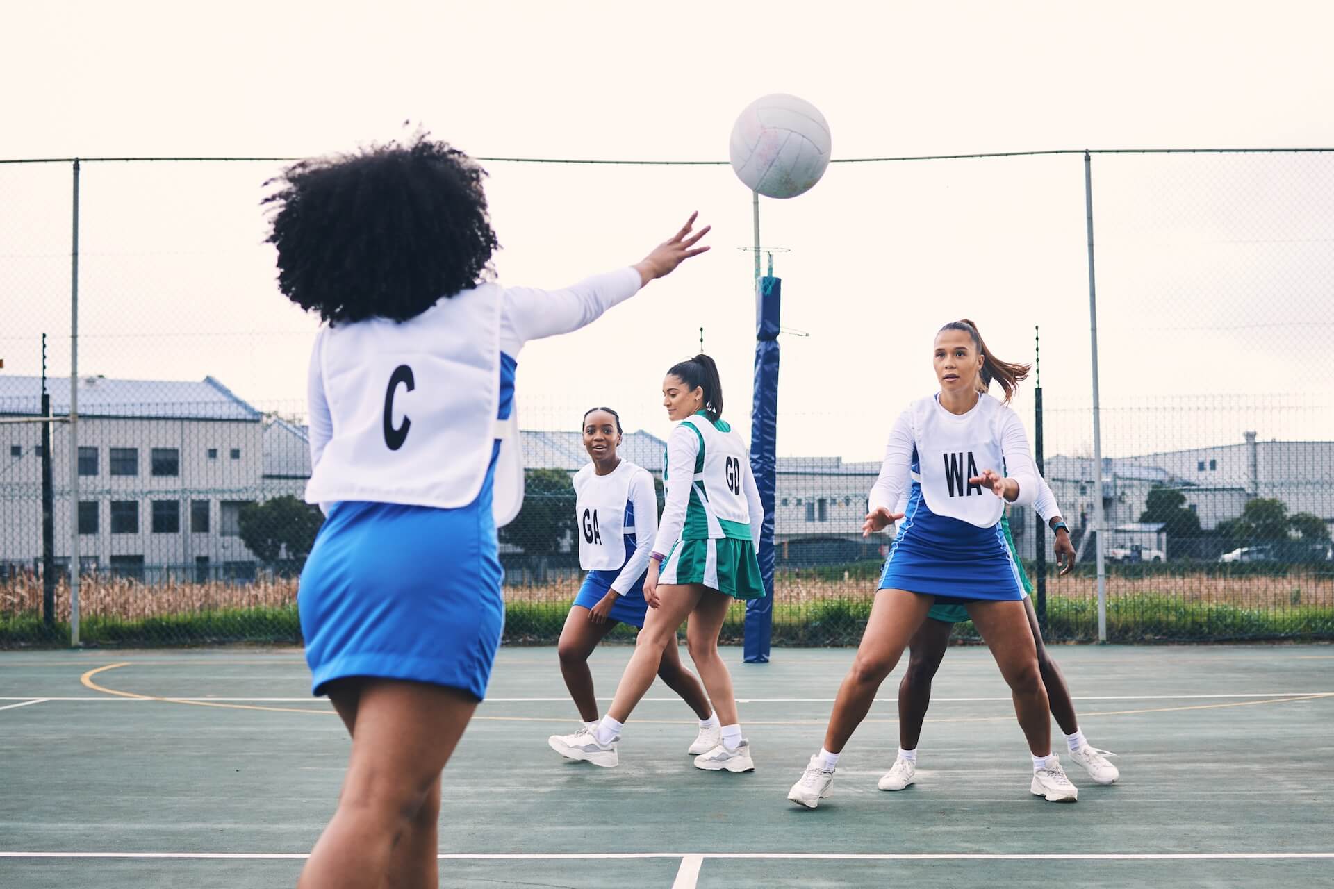 Women playing netball | Featured image for the Netball Court Cleaning page from MKL Pressure Cleaning.